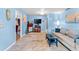 Bright living room with blue walls, tile flooring, and comfortable seating with large windows at 8315 W Elm St, Tampa, FL 33615