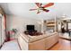 Open living area with hardwood floors, a ceiling fan, and a comfortable sectional sofa for relaxing and entertaining at 8315 W Elm St, Tampa, FL 33615