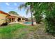 Charming backyard features a pool, well-kept lawn, and comfortable seating, ideal for relaxation and entertaining at 8315 W Elm St, Tampa, FL 33615