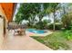 Inviting backyard pool with patio furniture and lush landscaping, perfect for outdoor relaxation and entertaining at 8315 W Elm St, Tampa, FL 33615