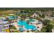 Aerial view showcases pool, splashpad, tennis courts, and homes in this vibrant community at 8413 Swiss Chard Cir, Land O Lakes, FL 34637