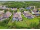 Overhead shot of homes showcasing their private pools, well-kept lawns, and green landscaping at 8413 Swiss Chard Cir, Land O Lakes, FL 34637