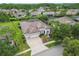 Beautiful aerial view of a home with a well-kept lawn, mature landscaping, and neighborhood at 8413 Swiss Chard Cir, Land O Lakes, FL 34637