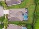 Aerial shot of a property featuring a screened pool, spacious backyard, and roof at 8413 Swiss Chard Cir, Land O Lakes, FL 34637