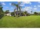 Expansive backyard with screened pool enclosure and lush landscaping offering a private oasis at 8413 Swiss Chard Cir, Land O Lakes, FL 34637