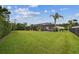 Large backyard features a screened pool area and mature trees providing a private outdoor space at 8413 Swiss Chard Cir, Land O Lakes, FL 34637