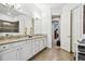 Bathroom featuring double vanities with granite countertops and decorative seahorse at 8413 Swiss Chard Cir, Land O Lakes, FL 34637