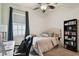 Well-lit bedroom with desk, bookcase, and ceiling fan at 8413 Swiss Chard Cir, Land O Lakes, FL 34637