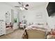 Bright bedroom with pastel colors, floral bedding, and a vanity area at 8413 Swiss Chard Cir, Land O Lakes, FL 34637