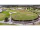 Expansive community green space with amphitheater, walking paths, and pond for leisure at 8413 Swiss Chard Cir, Land O Lakes, FL 34637