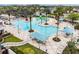 Large community pool area with ample seating, palm trees, and a splash zone for , promising fun for all at 8413 Swiss Chard Cir, Land O Lakes, FL 34637