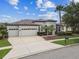Attractive home with a three-car garage, mature landscaping, and an inviting front entrance at 8413 Swiss Chard Cir, Land O Lakes, FL 34637