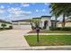 Elegant home with a well-manicured lawn, three-car garage, and a charming front entryway at 8413 Swiss Chard Cir, Land O Lakes, FL 34637