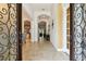 Open foyer with tile floors, arched doorways and decorative front doors at 8413 Swiss Chard Cir, Land O Lakes, FL 34637