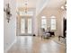 Elegant foyer with decorative glass front doors, high ceilings and tile floors at 8413 Swiss Chard Cir, Land O Lakes, FL 34637