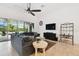 Bright living room featuring a ceiling fan, tile flooring and sliding glass doors at 8413 Swiss Chard Cir, Land O Lakes, FL 34637