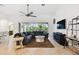 Bright living room with tile floors, comfortable sofa, and view of the outdoor area through sliding glass doors at 8413 Swiss Chard Cir, Land O Lakes, FL 34637