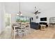 Open-concept living and dining area with a view to the outdoor patio, creating a seamless indoor-outdoor flow at 8413 Swiss Chard Cir, Land O Lakes, FL 34637