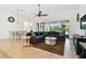 Inviting living space featuring tile flooring, a plush sofa, and an open layout leading to the dining area at 8413 Swiss Chard Cir, Land O Lakes, FL 34637