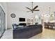 Stylish living room with comfortable seating, a sleek TV setup, and easy access to the outdoor area at 8413 Swiss Chard Cir, Land O Lakes, FL 34637