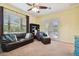 The comfortable living room has carpet floors and access to the outdoor pool area at 8413 Swiss Chard Cir, Land O Lakes, FL 34637
