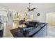 Open-concept living area with a spacious sofa and seamless flow into the modern kitchen at 8413 Swiss Chard Cir, Land O Lakes, FL 34637
