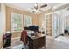 Comfortable office space with neutral paint, carpeted floor, ceiling fan and bright windows at 8413 Swiss Chard Cir, Land O Lakes, FL 34637
