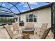 Enjoy outdoor dining and lounging by the pool from the covered patio at 8413 Swiss Chard Cir, Land O Lakes, FL 34637
