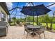 Spacious screened patio with dining set and grilling area, perfect for outdoor dining and entertaining at 8413 Swiss Chard Cir, Land O Lakes, FL 34637