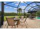 An outdoor firepit and seating create a cozy gathering place on the screened-in patio at 8413 Swiss Chard Cir, Land O Lakes, FL 34637