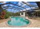 Inviting screened pool area featuring a pristine pool and ample seating for relaxation and outdoor enjoyment at 8413 Swiss Chard Cir, Land O Lakes, FL 34637