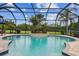 Beautiful in-ground pool features a center island with lush plantings in a screened enclosure at 8413 Swiss Chard Cir, Land O Lakes, FL 34637