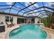 Stunning screened pool with multiple seating areas and tropical landscaping, perfect for relaxation and entertaining at 8413 Swiss Chard Cir, Land O Lakes, FL 34637