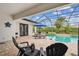 Outdoor living is emphasized by this screened-in patio with outdoor seating and lush landscaping at 8413 Swiss Chard Cir, Land O Lakes, FL 34637