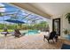 Enjoy poolside lounging with covered, screened-in outdoor living space at 8413 Swiss Chard Cir, Land O Lakes, FL 34637