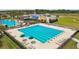 Community pool with lap lanes and lounge area next to the clubhouse on a sunny day at 8413 Swiss Chard Cir, Land O Lakes, FL 34637