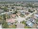 An aerial view of a quiet neighborhood with well-maintained homes, tree-lined streets, and community pools at 8521 Caitlin Ct, Hudson, FL 34667