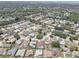 Beautiful aerial view of a residential neighborhood with mature trees and well-maintained homes, some featuring private pools at 8521 Caitlin Ct, Hudson, FL 34667