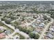 Expansive aerial view of a residential community featuring a variety of homes, streets, and lush greenery at 8521 Caitlin Ct, Hudson, FL 34667