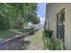 Scenic backyard view showcasing lush landscaping and a screened-in pool area, perfect for outdoor living at 8521 Caitlin Ct, Hudson, FL 34667