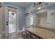 Bathroom features granite countertops, ample cabinetry, and a door to the outdoors at 8521 Caitlin Ct, Hudson, FL 34667