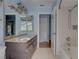 Well-lit bathroom featuring granite countertops, wood cabinets, and a convenient shower at 8521 Caitlin Ct, Hudson, FL 34667