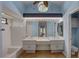 The bright bathroom features double vanities and decorative accents at 8521 Caitlin Ct, Hudson, FL 34667