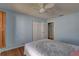 Bright bedroom with a ceiling fan, closet, and wooden floors offers comfort and style at 8521 Caitlin Ct, Hudson, FL 34667