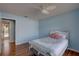 This bedroom has a light blue color palette and wood floors at 8521 Caitlin Ct, Hudson, FL 34667