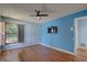 Bedroom with hardwood floors, a ceiling fan, and a mounted TV offers relaxation at 8521 Caitlin Ct, Hudson, FL 34667