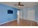 Bright bedroom with hardwood floors, TV, and closet space ensures comfortable living at 8521 Caitlin Ct, Hudson, FL 34667