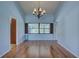 Charming dining room with hardwood floors, a chandelier, and neutral paint at 8521 Caitlin Ct, Hudson, FL 34667
