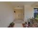 Welcoming front entrance with double doors, decorative plants, and tiled entryway at 8521 Caitlin Ct, Hudson, FL 34667