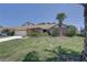 Charming home showcasing brick facade, well-kept lawn, mature trees and swaying palm trees at 8521 Caitlin Ct, Hudson, FL 34667